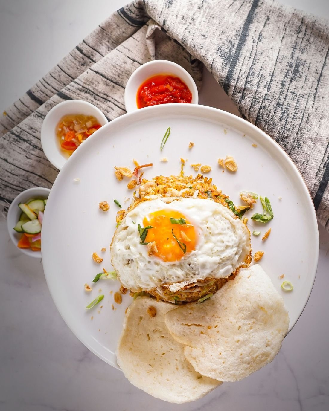 Sepiring nasi goreng dengan telur, siap ditemani sambal